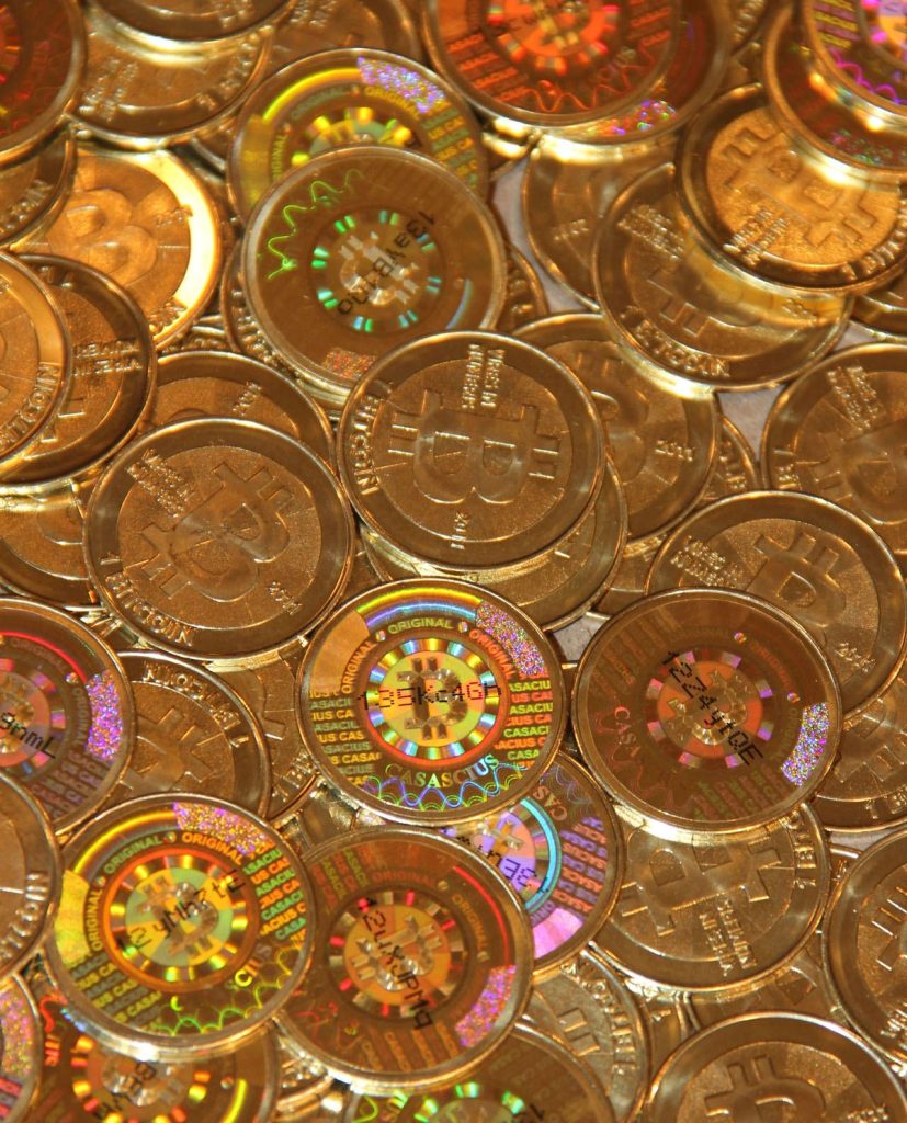 Physical bitcoin tokens arranged on a dark surface